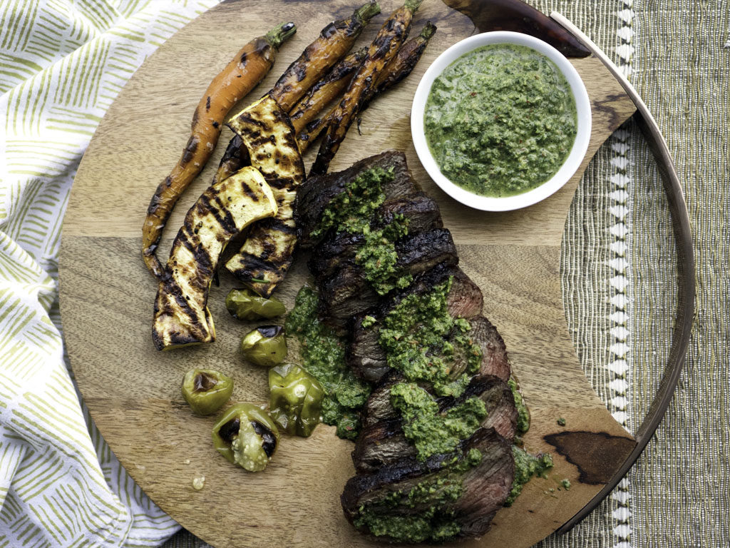 carrot top chimichurri over grilled steak and vegetables