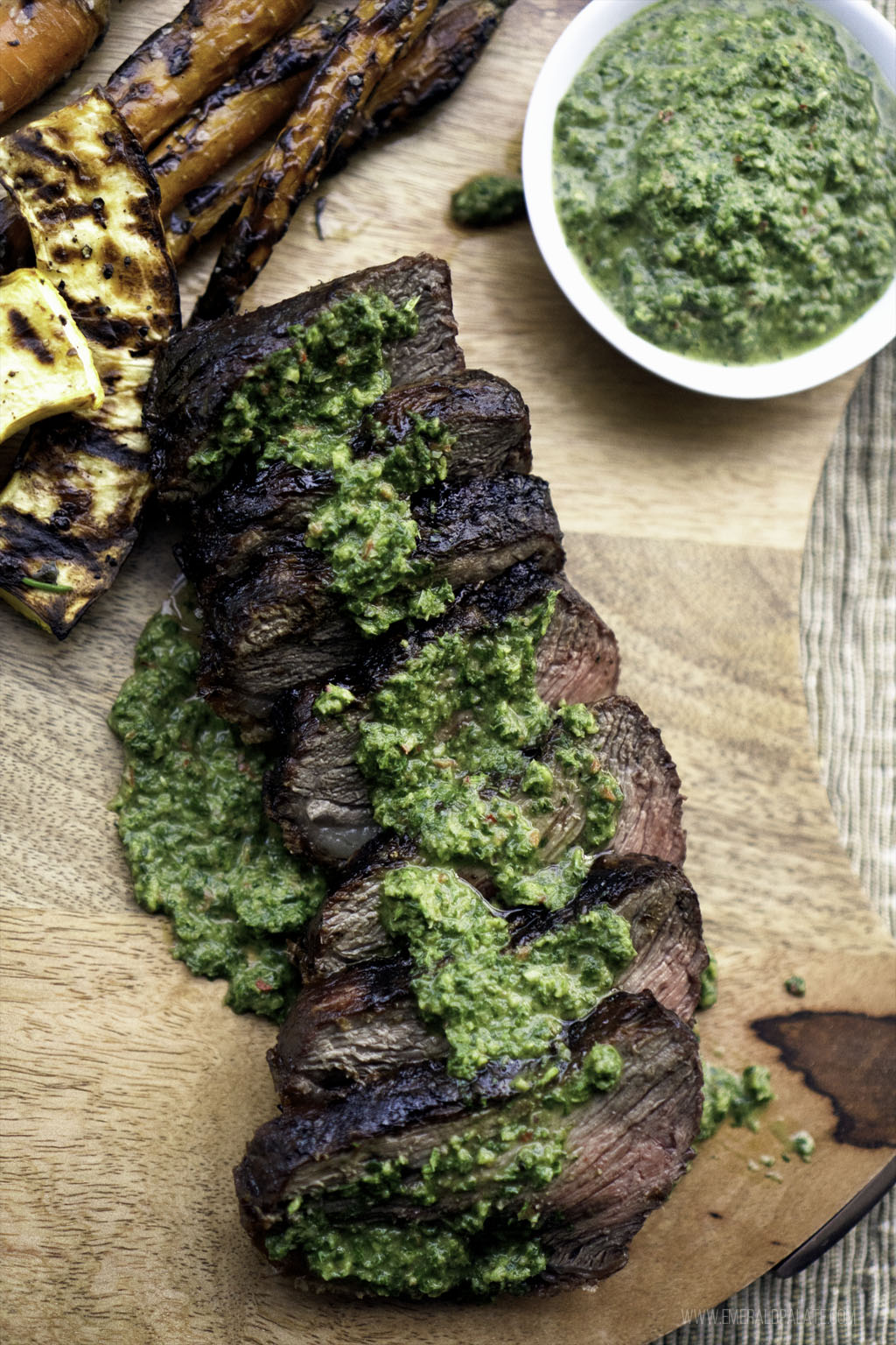 carrot greens chimichurri drizzled over sliced steak