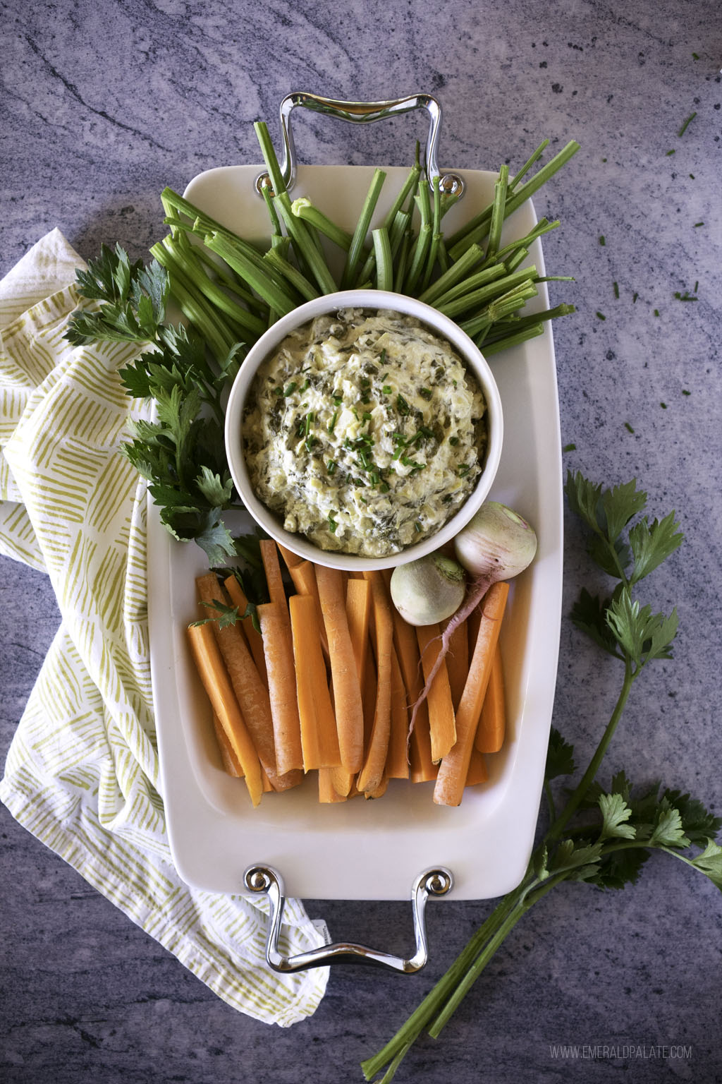 Platter of carrot and celery with a celery root dip, a healthy take on an artichoke spinach dip