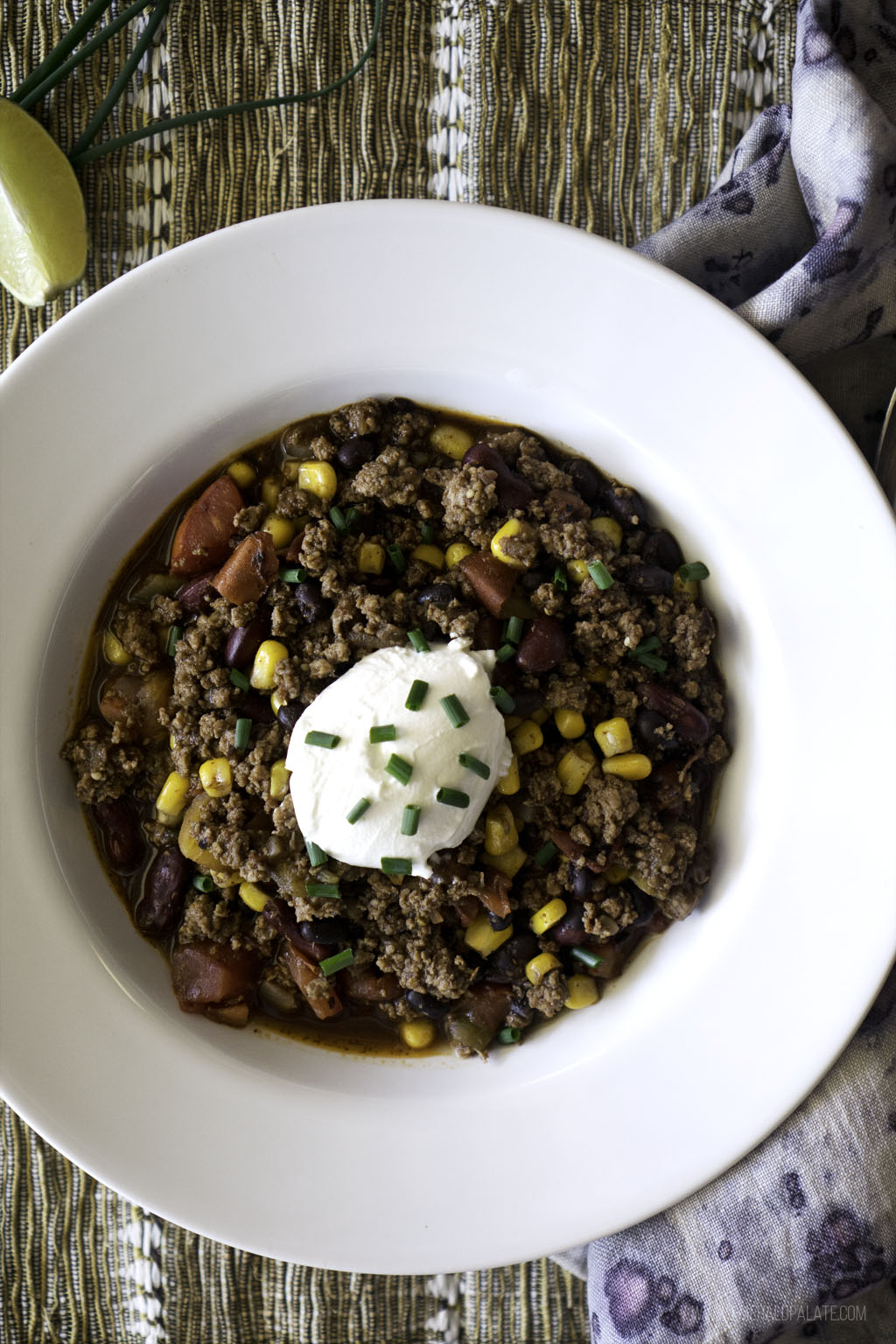 bowl of turkey chili with cocoa powder and sour cream