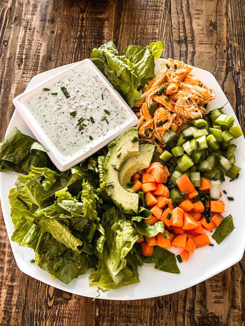 plate of shredded buffalo chicken salad, a healthy Super Bowl party recipe