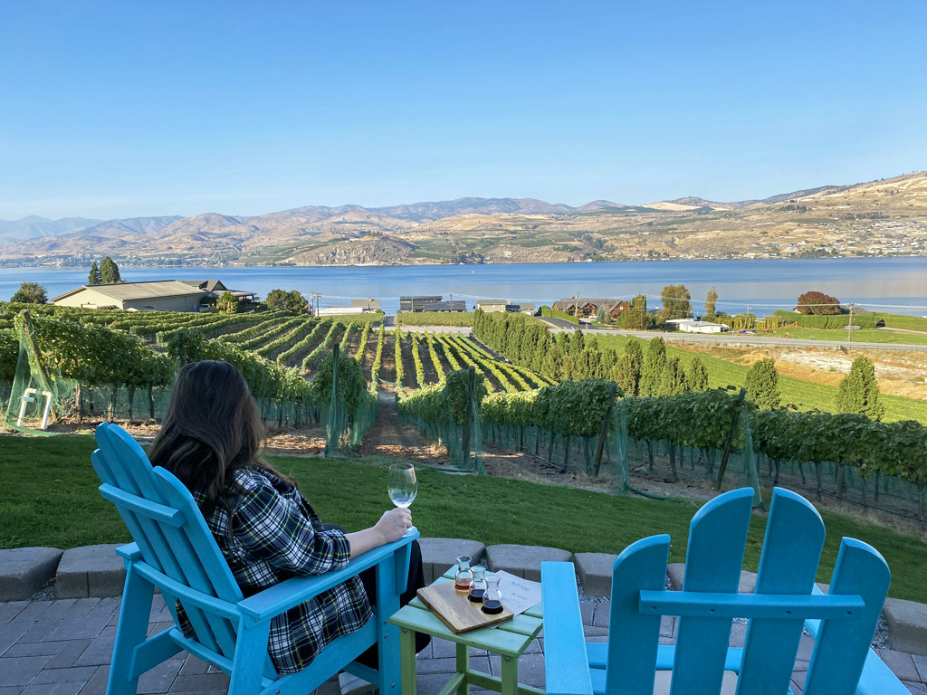 women sipping wine from a patio in Lake Chelan, one of the most romantic getaways in the Pacific Northwest