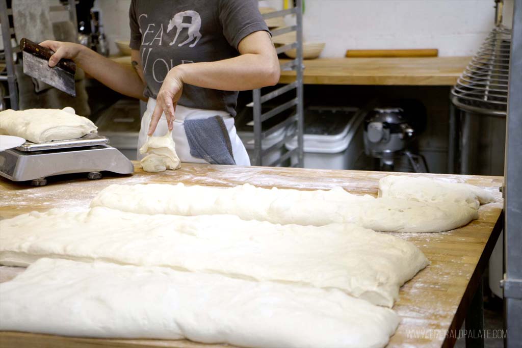person preparing dough for a cooking class, one of the best Seattle for foodies bucket list activities