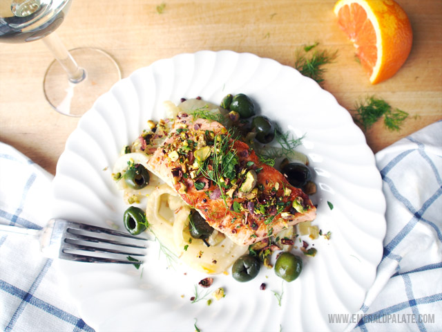 An easy and healthy Valentine's Day recipe featuring salmon, fennel, roast orange, and a pistachio-cacao nib gremolata.