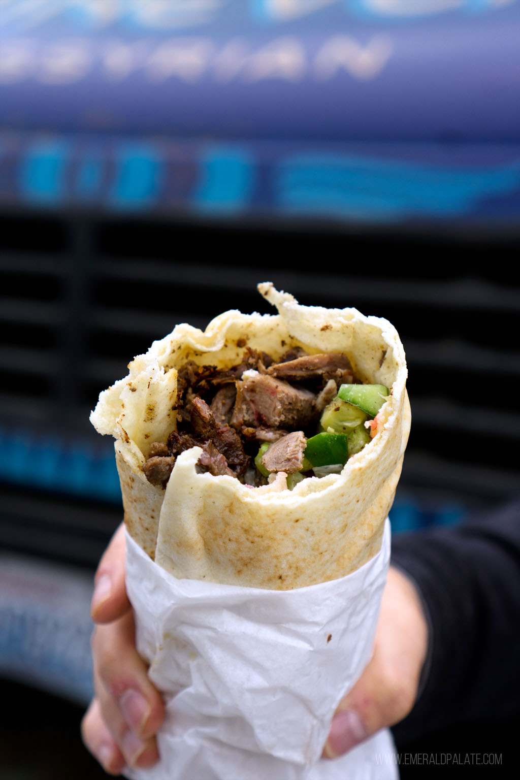 person holding half eaten shawarma wrap from an Olympia, WA restaurant