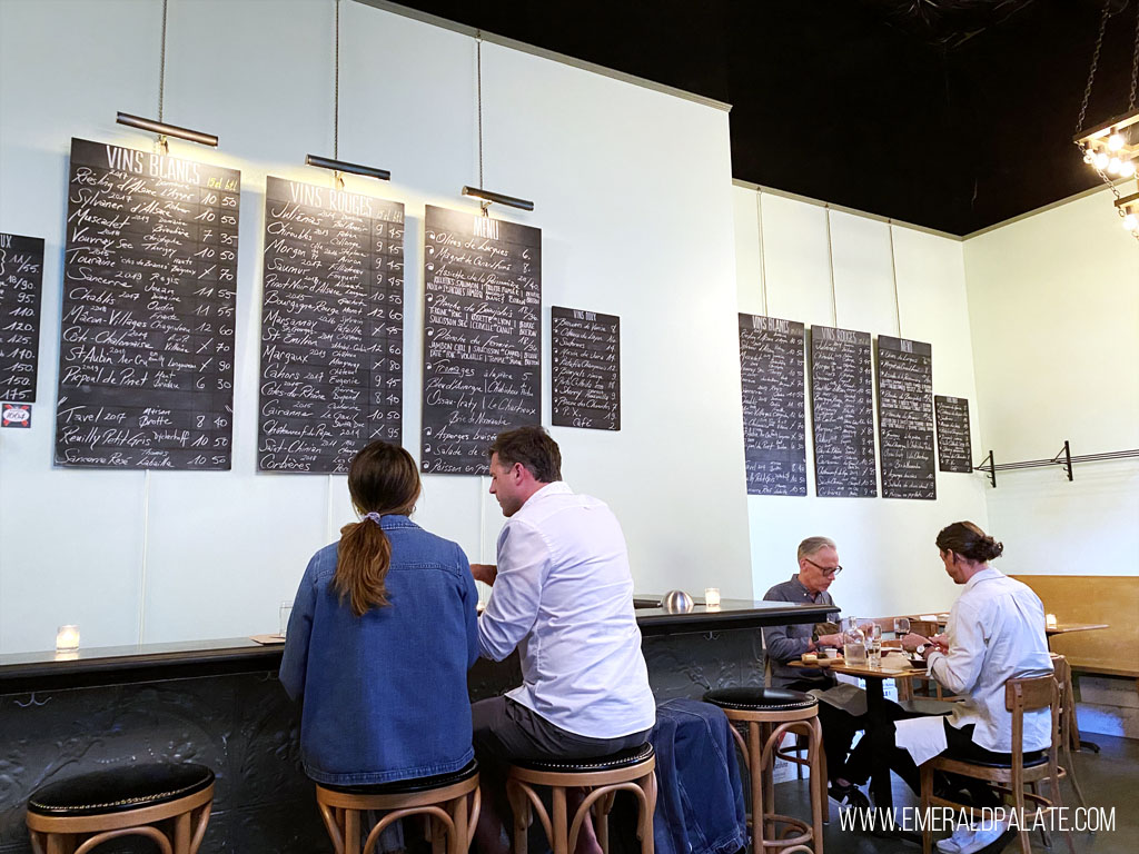 people sitting inside a French wine bar in Seattle