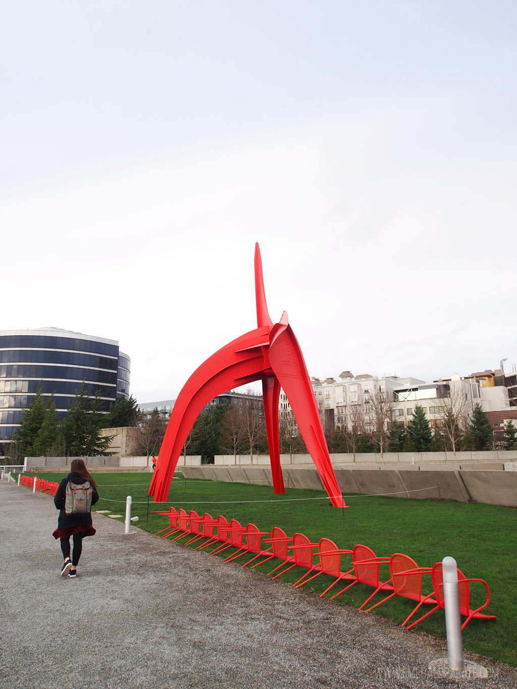 woman walking in the Olympic Sculpture Park, a great way to spend 24 hours in Seattle