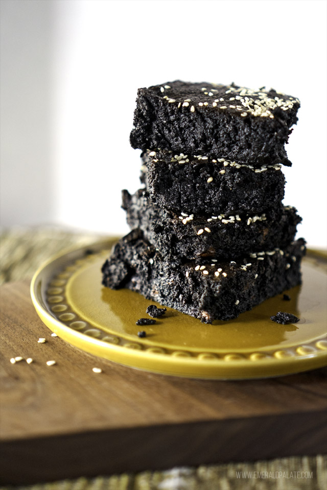 4 coconut banana fudge brownies on a plate with sesame seeds