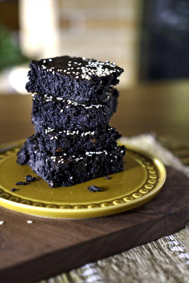 4 brownies with coconut and banana stacked on a plate in a living room
