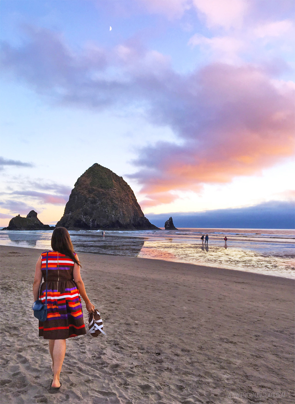 woman walking toward Haystack Rock, one of the best things to do near Cannon Beach