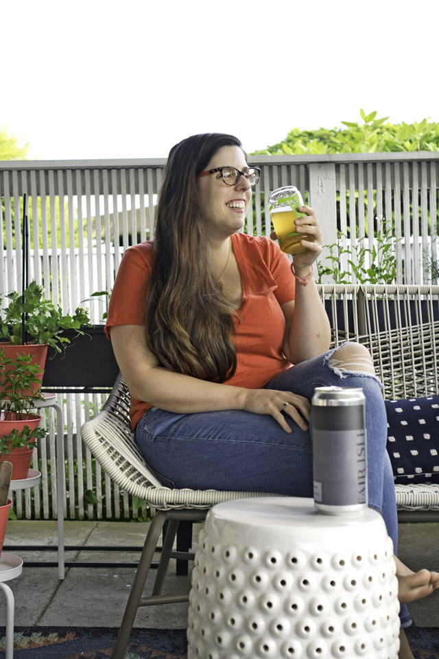 woman enjoying Fair Isle Brewing beer