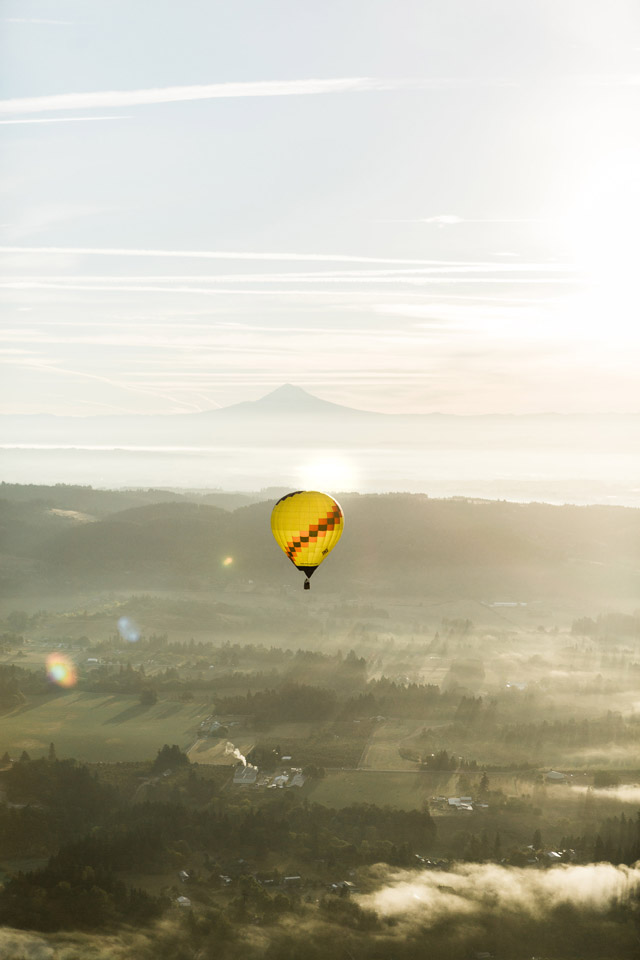 View of a hot air balloon at sunrise in front of Mt Adams 
