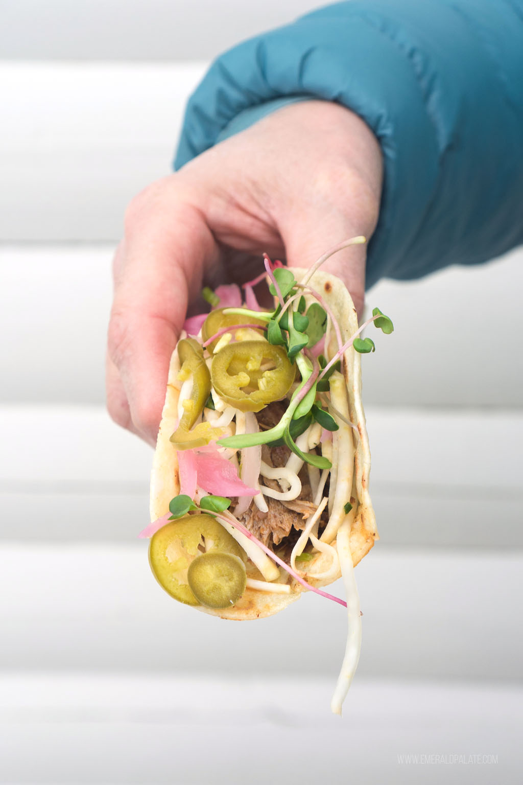 person holding heaping taco from a top Leavenworth restaurant