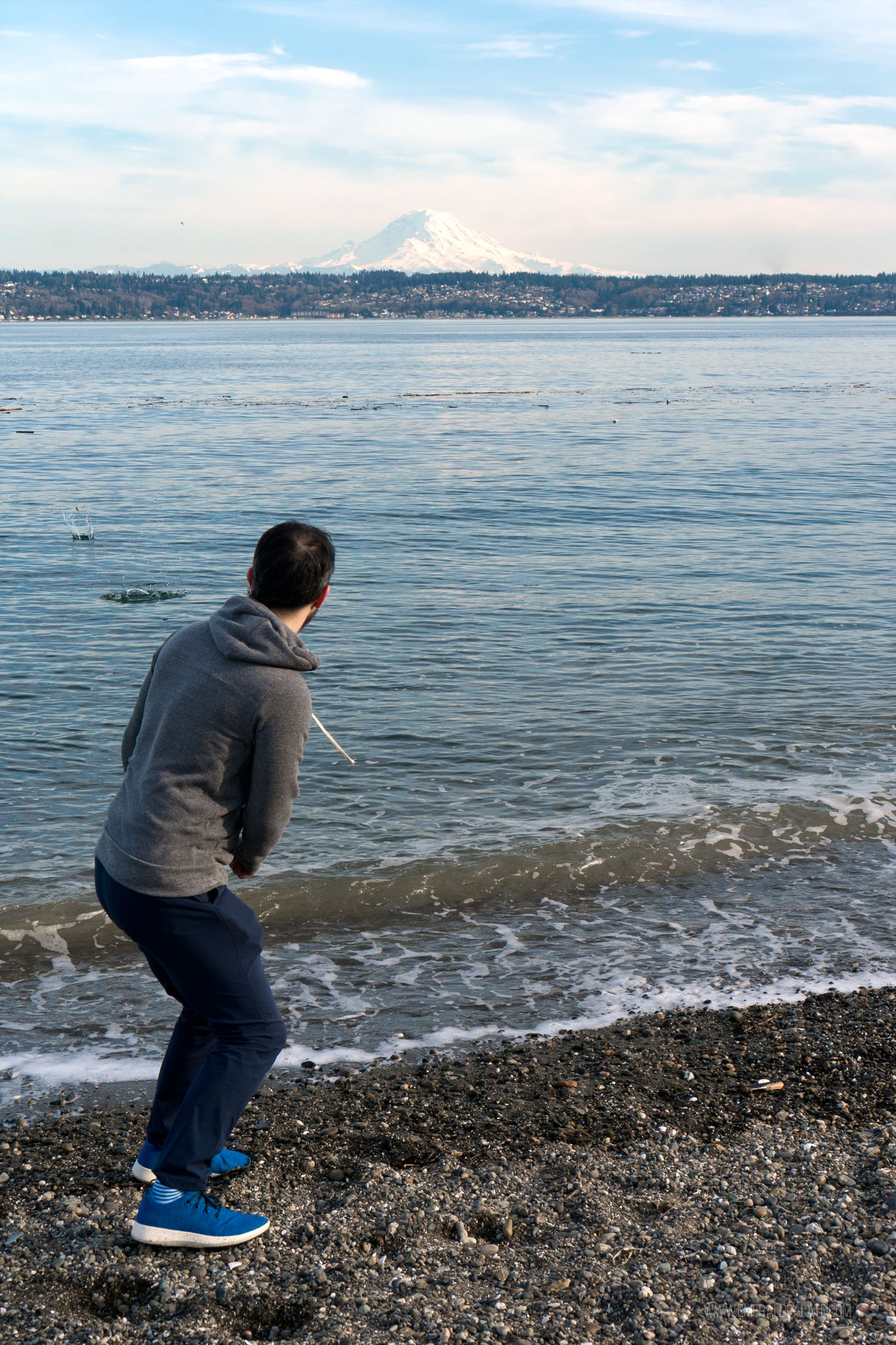 man skipping rocks