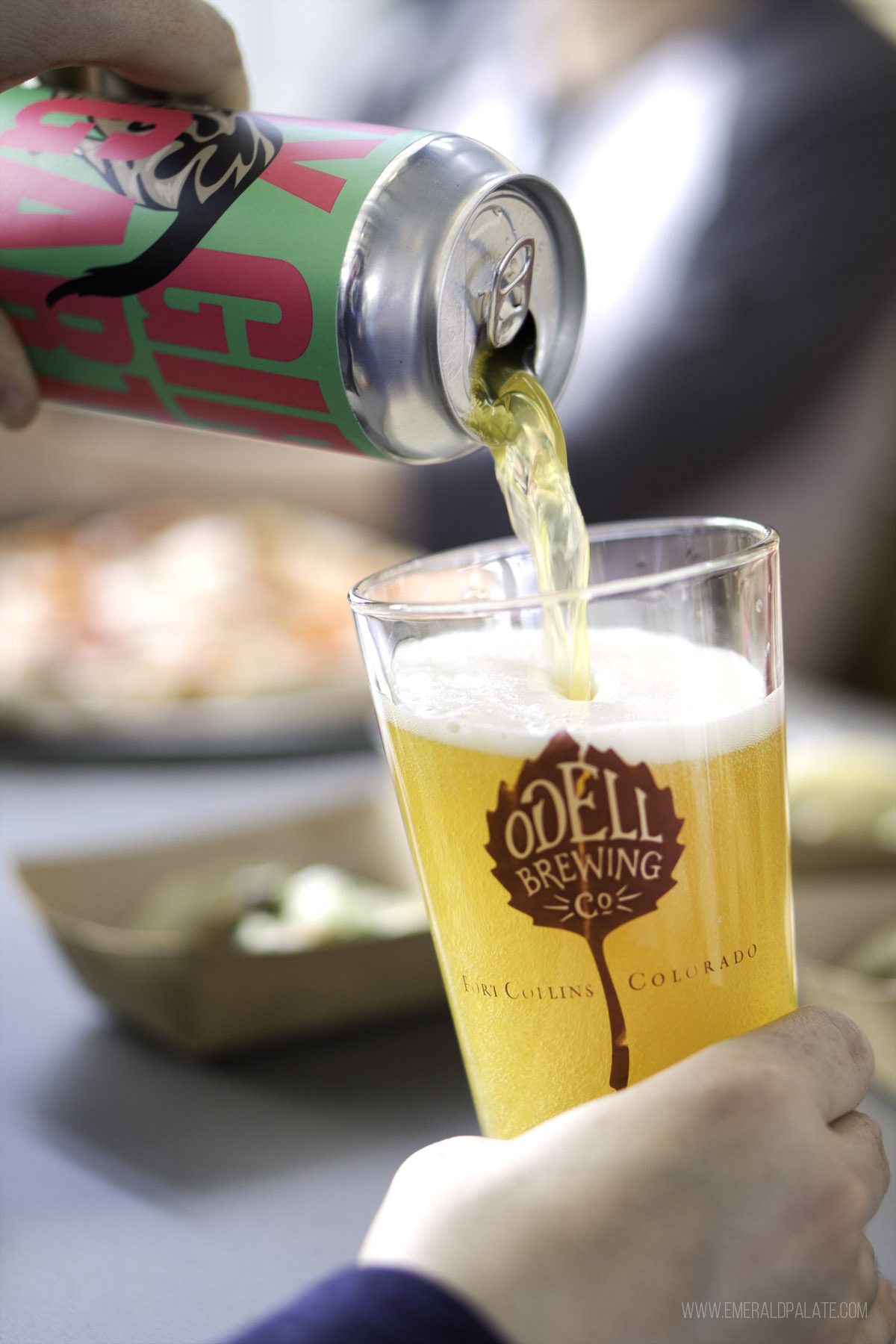 person pouring beer in a glass