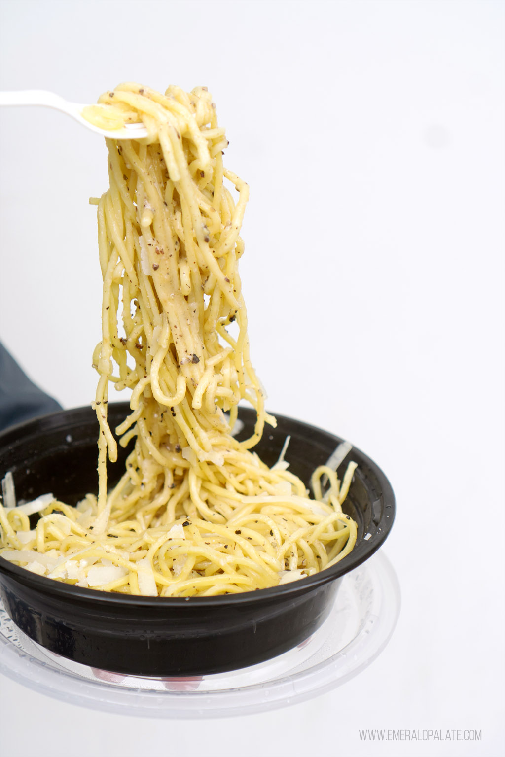 cacio e pepe spaghetti being pulled high on a fork from a pasta restaurant in Seattle