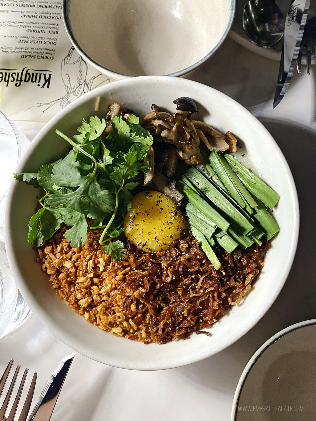 bowl of congee with an egg from a must-try San Diego restaurant