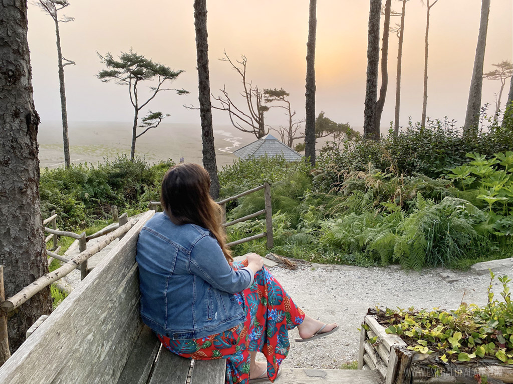 woman watching sunset at Seabrook, WA, one of the best Washington coast attractions