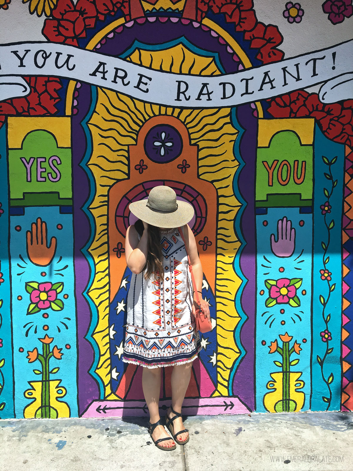 woman standing in front of a colorful mural in North Park San Diego