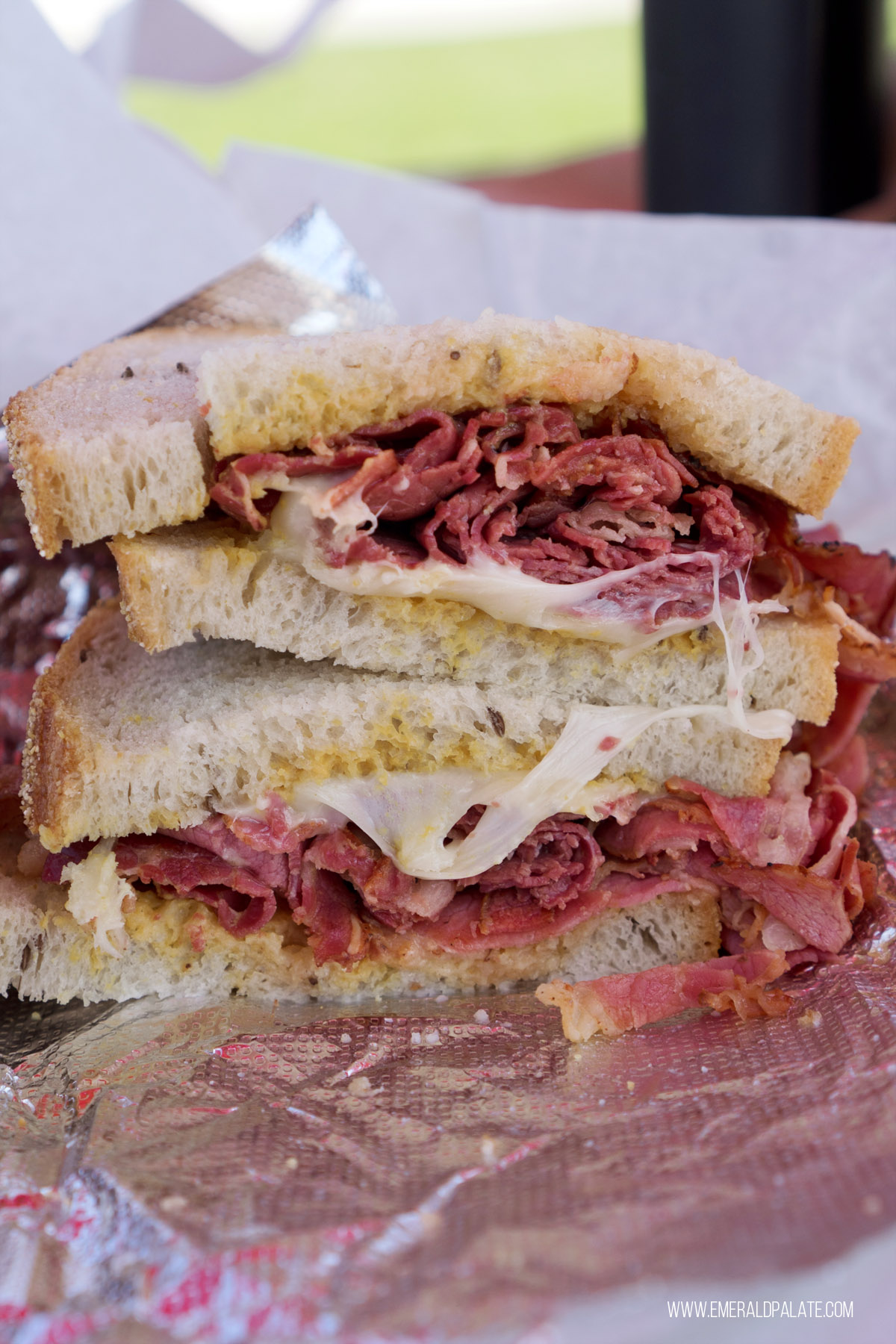 Two halves of a Rueben sandwich stacked on top of each other