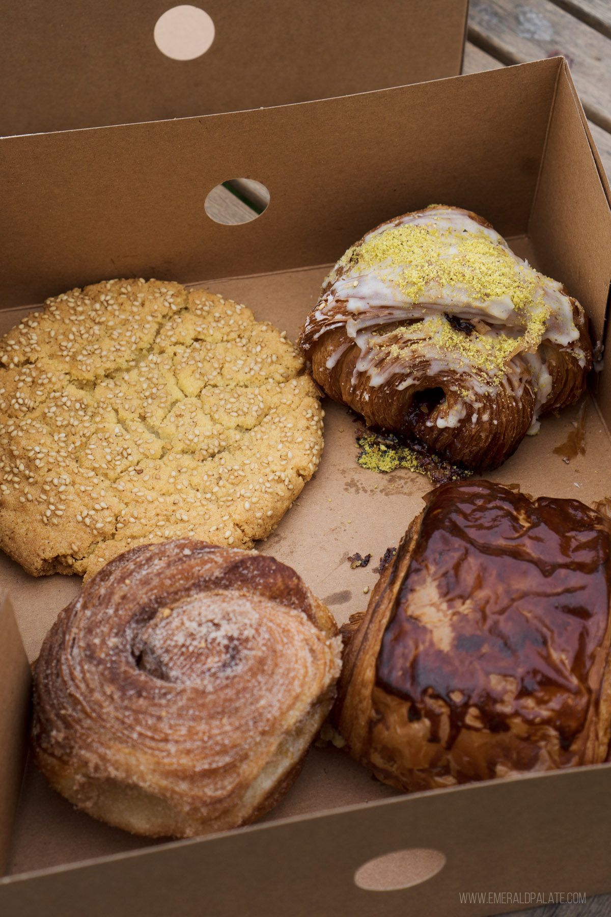 takeout container of cookies and croissants