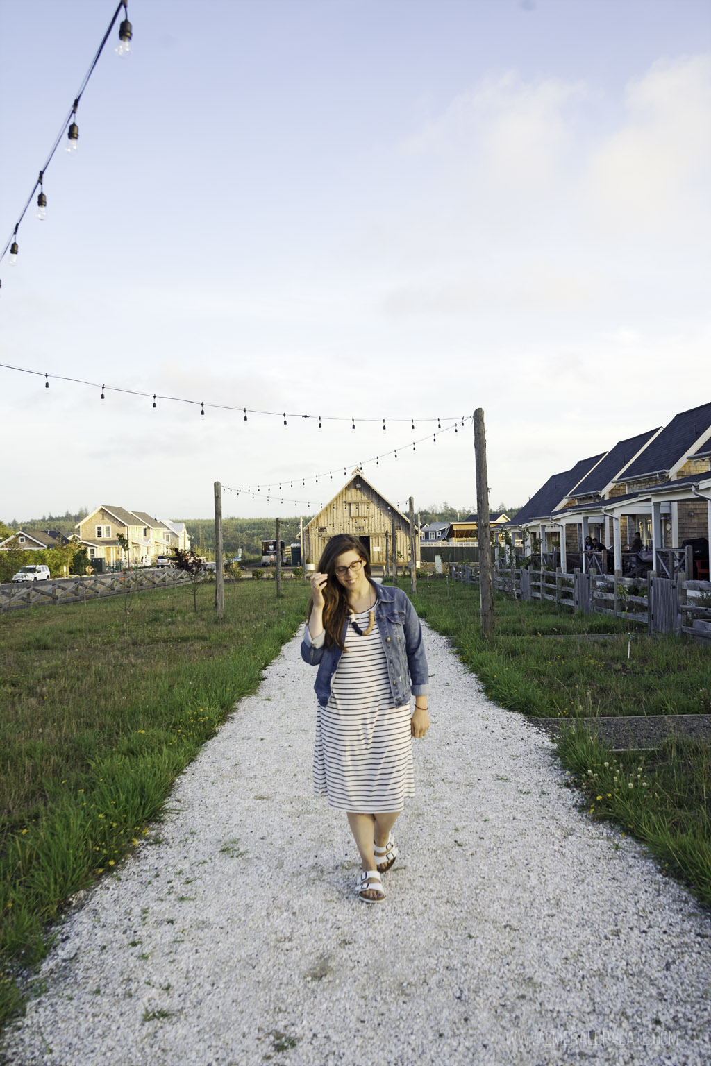 woman walking in the town of Seabrook, a quaint Washington beach town