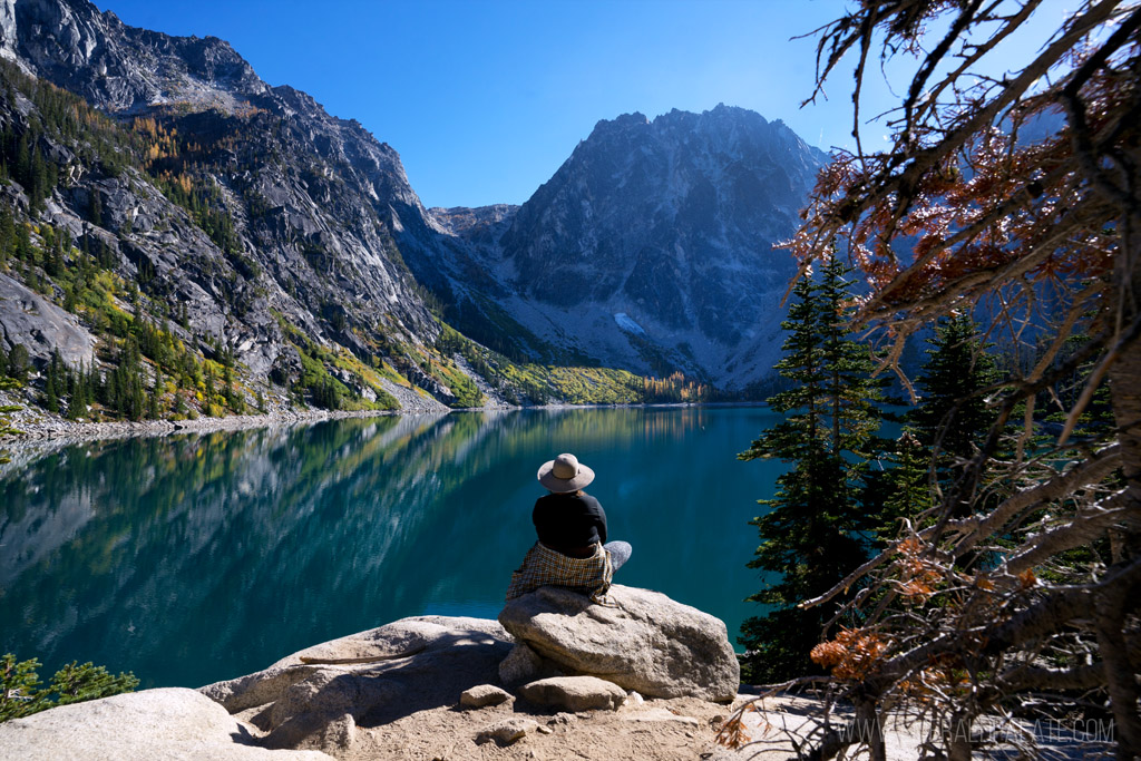 woman enjoying the view at the summit of Colcuck late, one of the best larch hikes