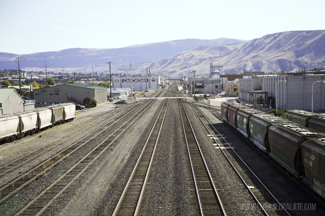 View of the train tracks running through downtown Wenatchee, WA with views of the Wenatchee Valley