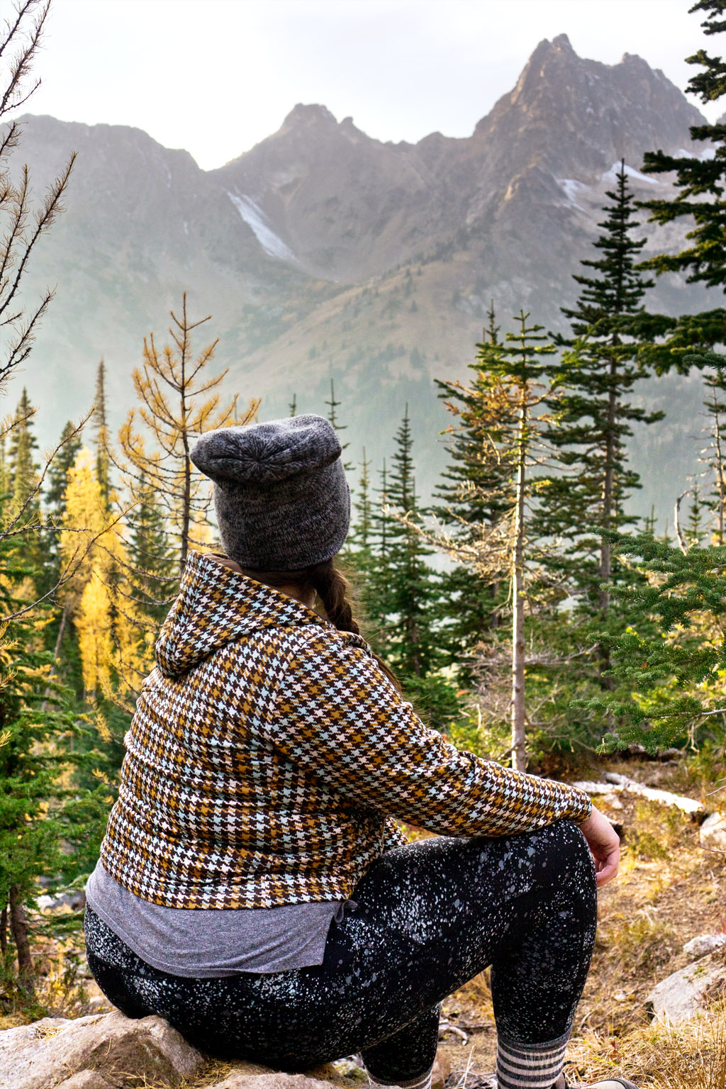 woman overlooking Cascade Mountains on one of the best larch hikes in Washington
