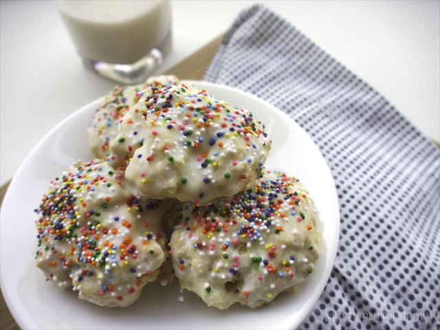 cookie with rainbow sprinkles, icing, and served with milk