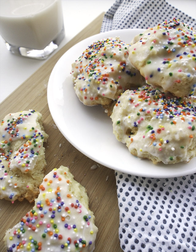 cookie with rainbow sprinkles, icing, and served with milk