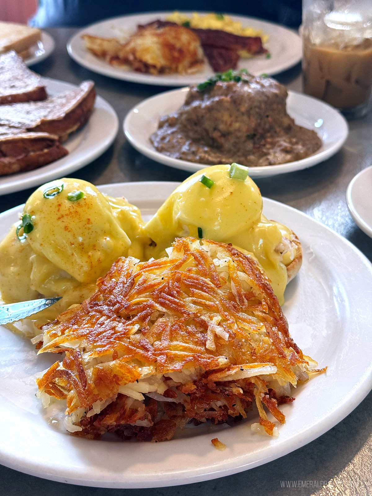 eggs benedict and hash browns at one of Seattle's best brunch spots