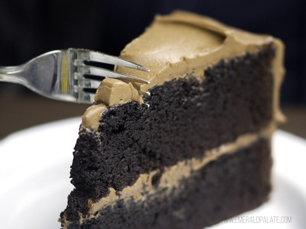 large chocolate cake fork going into large chocolate cake from one of the best dessert places in Seattle