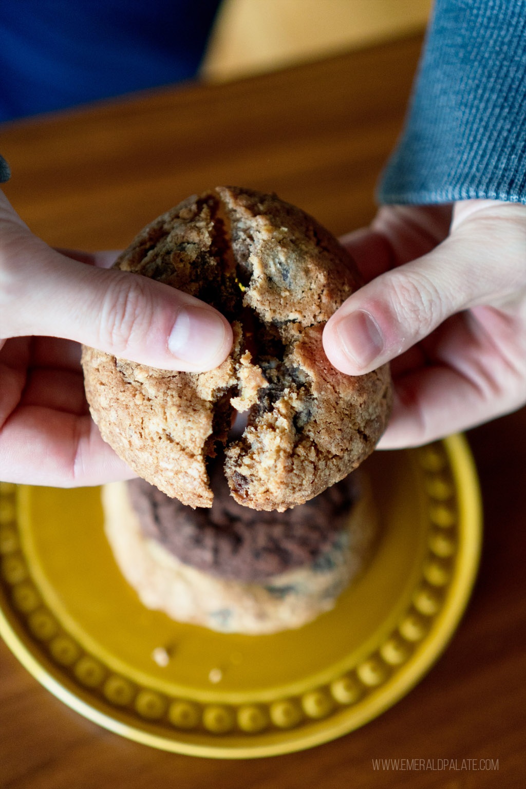 person breaking apart one of the best cookies in Seattle