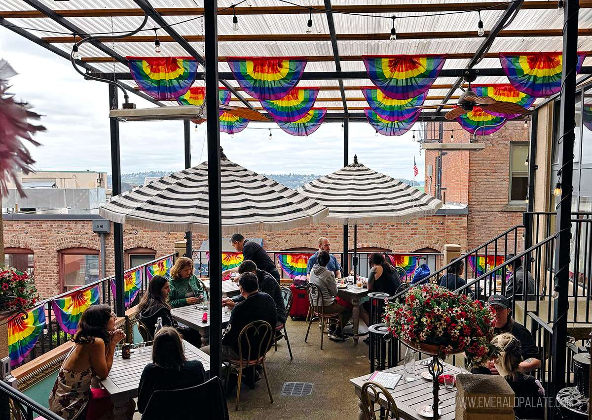patio with umbrellas and pride flags at one of the best brunch spots in Seattle