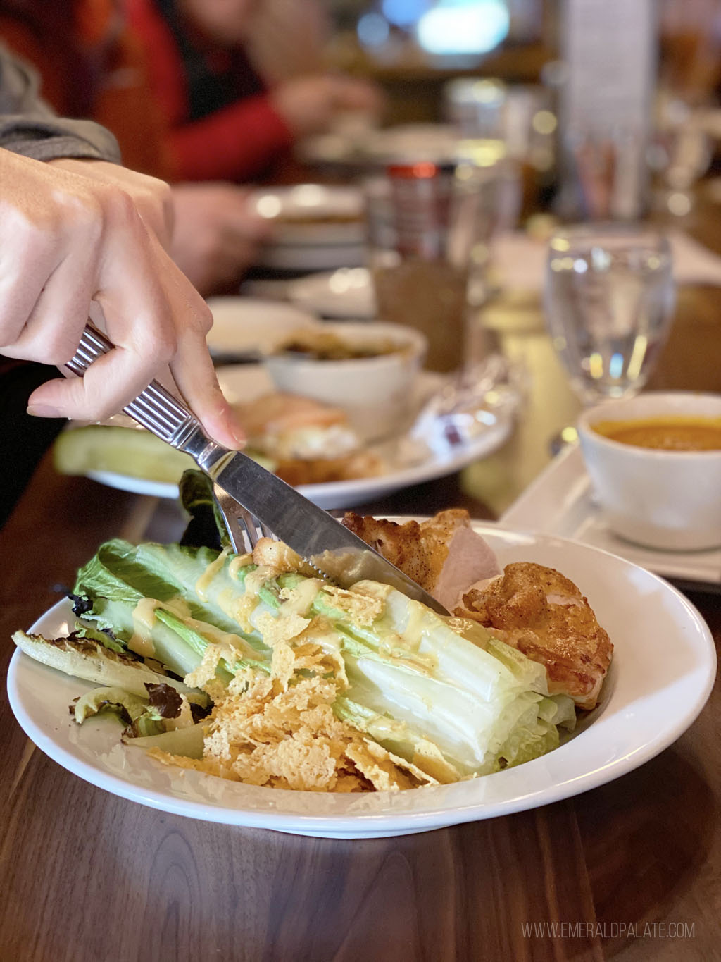 person cutting into a wedge salad at a Mt Hood ski resort