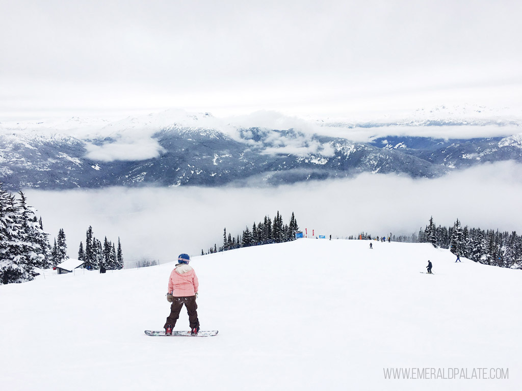 woman snowboarding down mountain