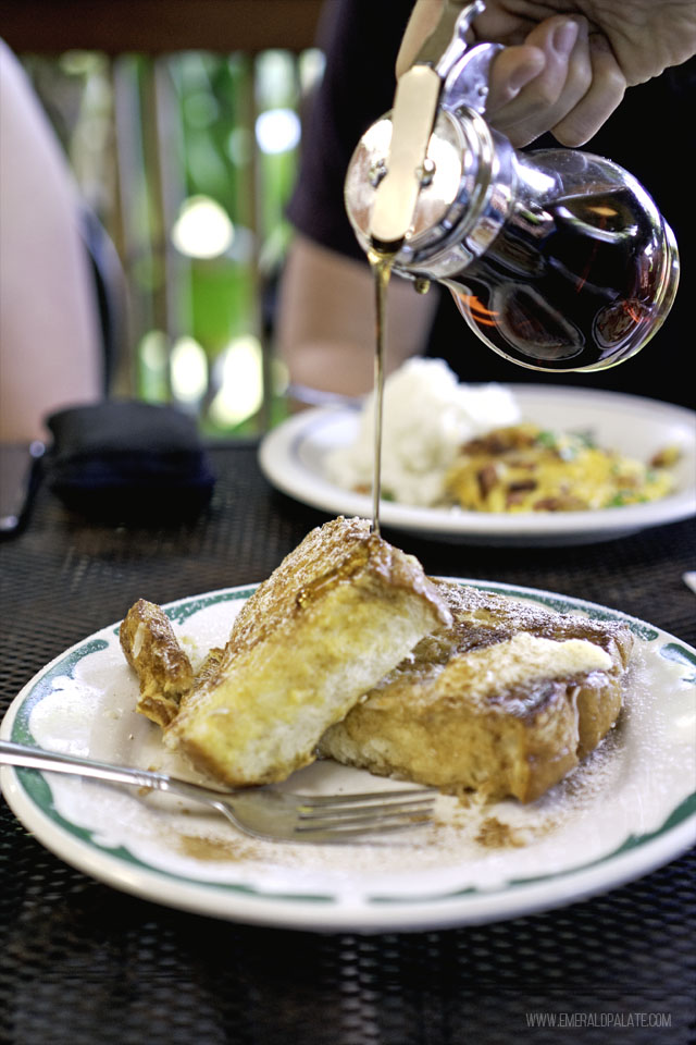 person pouring maple syrup over french toast at one of the best breakfasts in Maui