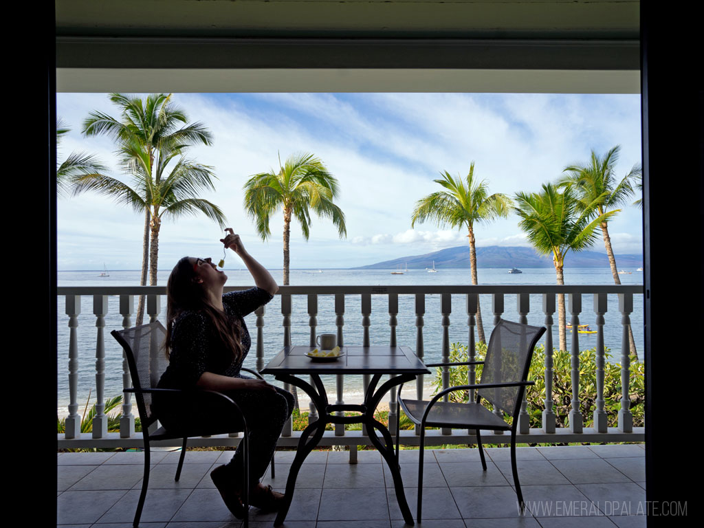 woman eating fruit on hotel balcony