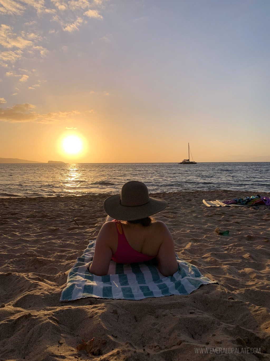 woman lounging on a Maui beach great for snorkeling