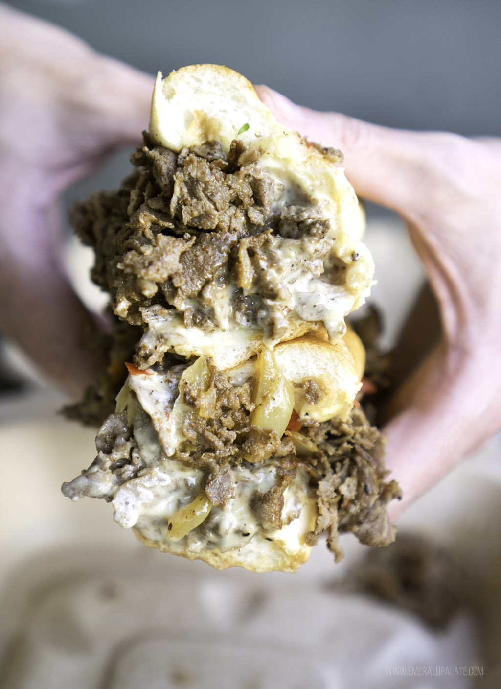 close up of stacked halves of a cheesesteak sandwich from one of the best casual restaurants in Seattle for cheap eats