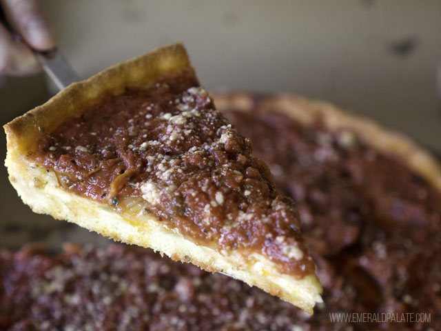 Slide of Chicago style pizza with tomato sauce at where you can find the best pizza in Seattle