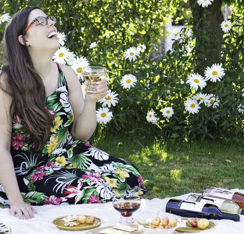 woman enjoying a picnic with wine from the best Seattle wine stores