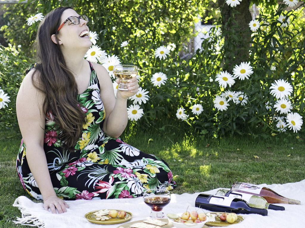 woman laughing at a picnic with wine from the best Seattle wine shops