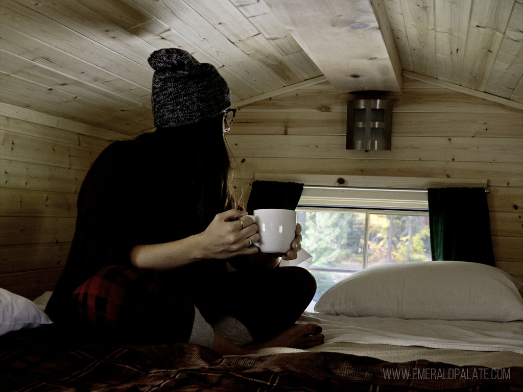woman sitting in cabin while glamping in Washington state