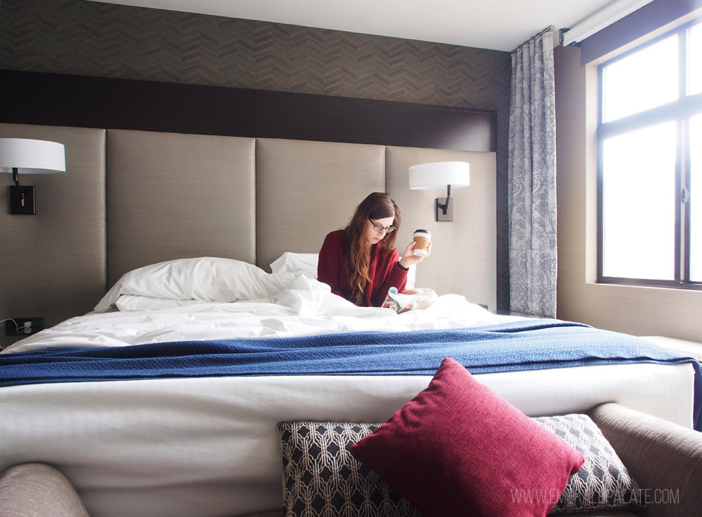 woman in bed at The Paramount Hotel, a cool place to stay in Seattle