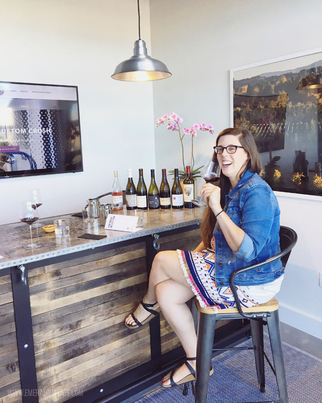 woman wine tasting at a wine shop, part of a roundup of the best Seattle wine stores