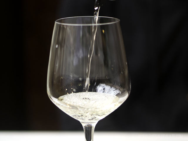 White wine being poured in a glass at winery on Bainbridge Island