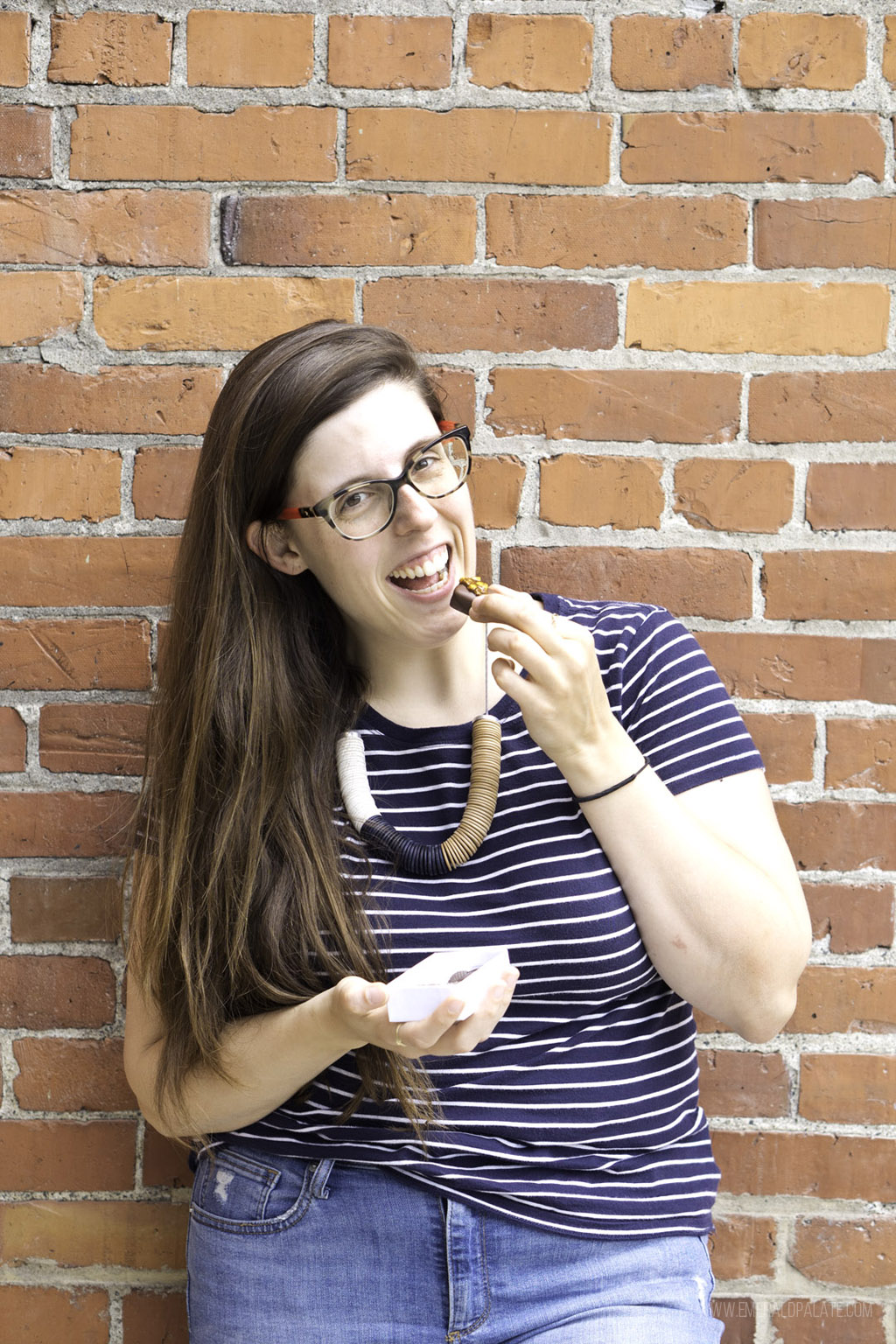 woman eating chocolate from one of the best chocolate shops in Seattle