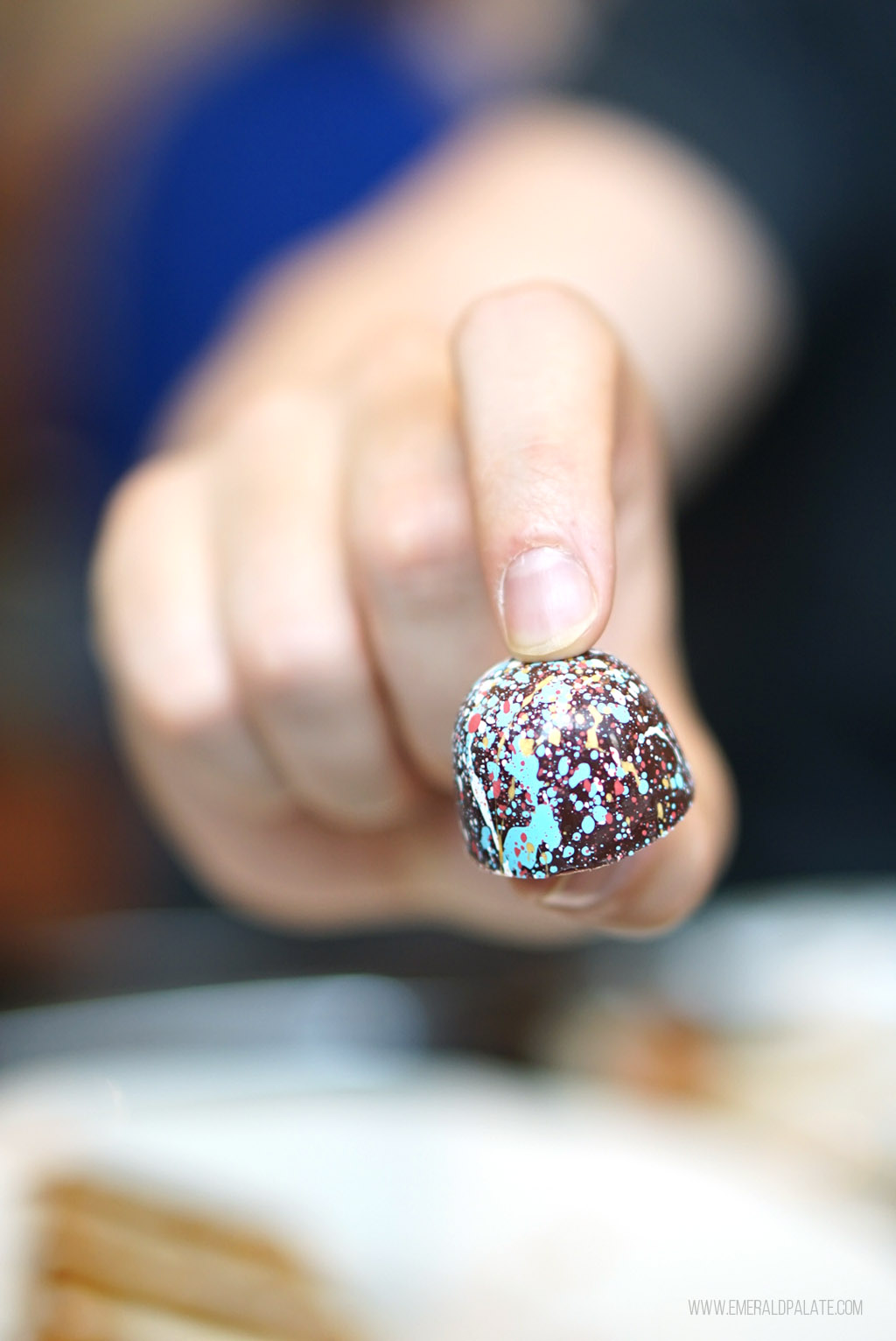 person holding a truffle from some of the best Seattle chocolate